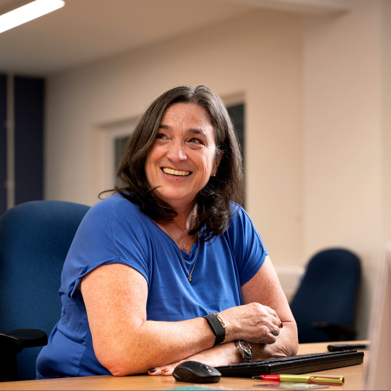 Gail smiling at her desk